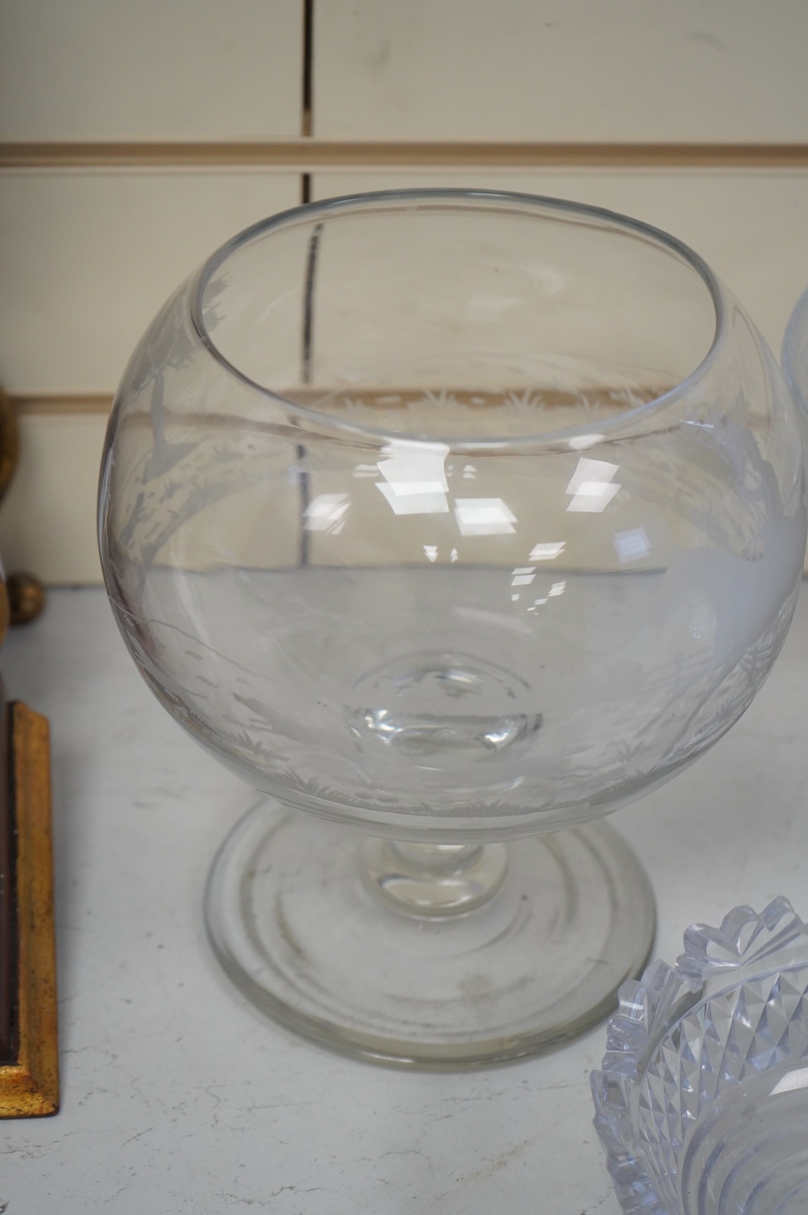 Two footed glass bowls engraved with racing and hunting scenes, an early 19th century oval cut glass fruit bowl, another, modern, together with a small Regency mallet shaped decanter, with an enamel label ‘’Whisky’’, (6)